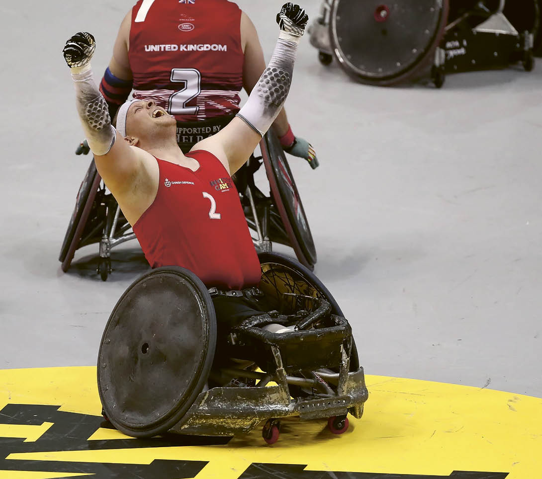 A man in a wheelchair is celebrating. Description generated by AI