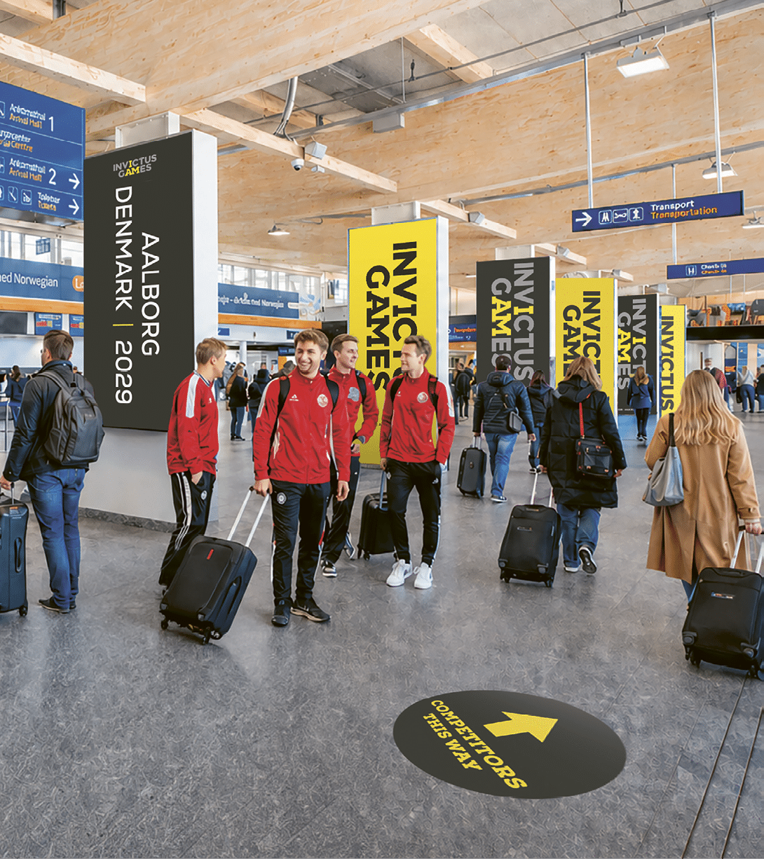 A group of people are in a terminal with luggage. Description generated by AI
