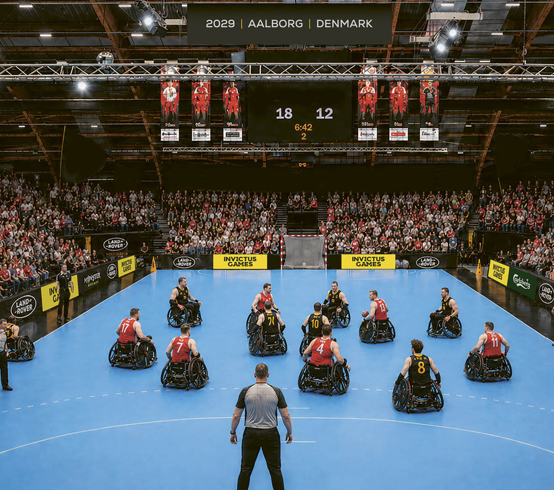 A man is standing in front of a group of people on a blue court. Description generated by AI