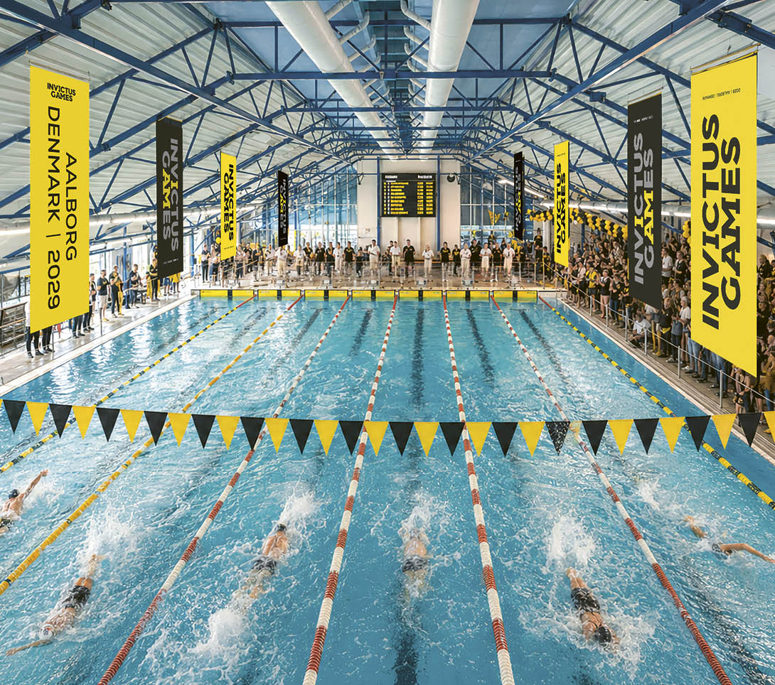 Swimmers in a pool with a crowd watching. Description generated by AI
