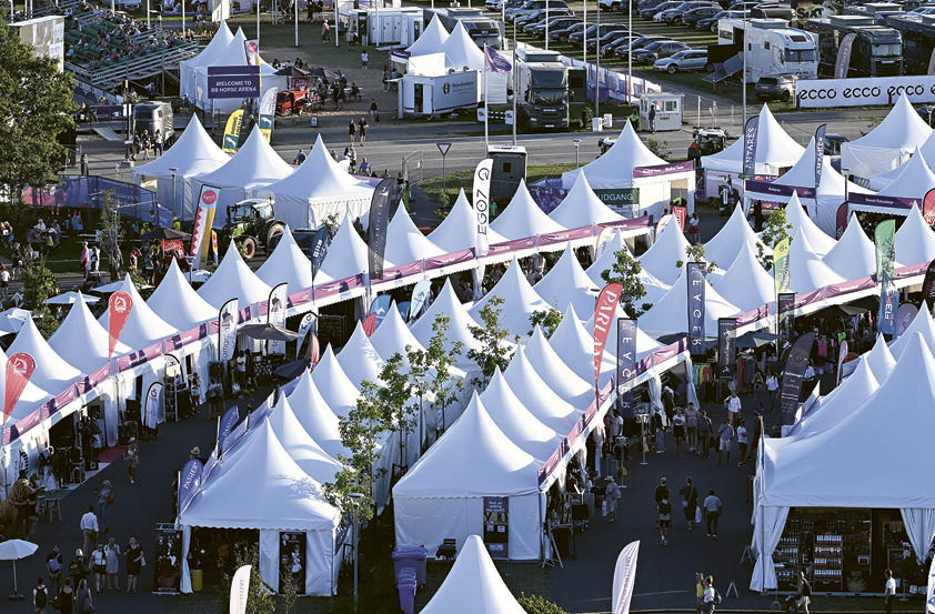 A large white tent with a pink roof. Description generated by AI