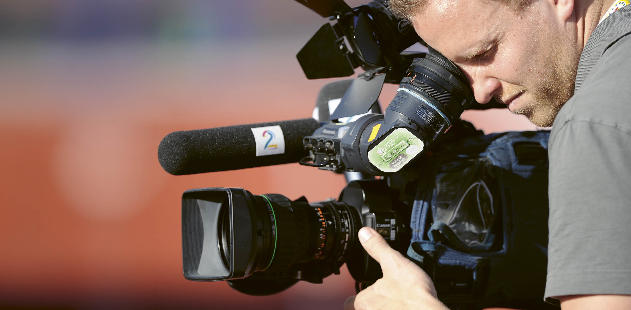 A man is holding a camera. Description generated by AI